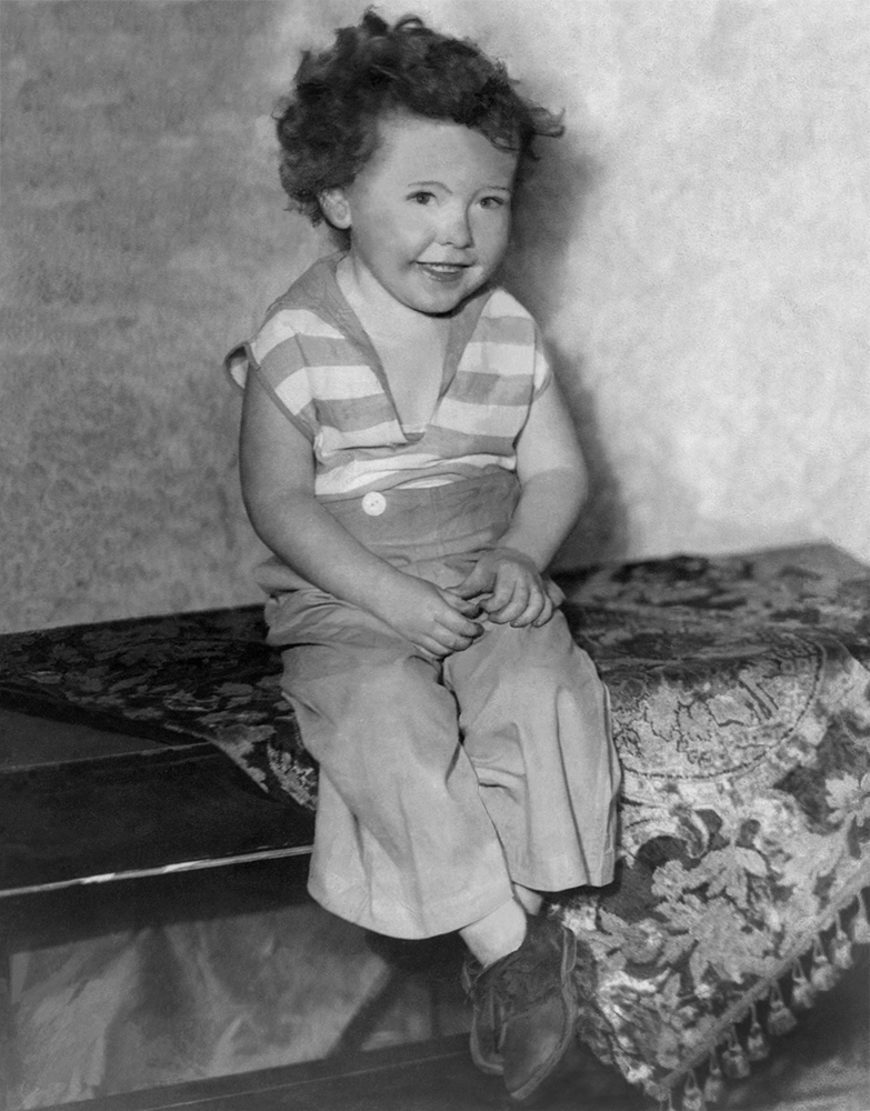 An old photo of a toddler-age boy